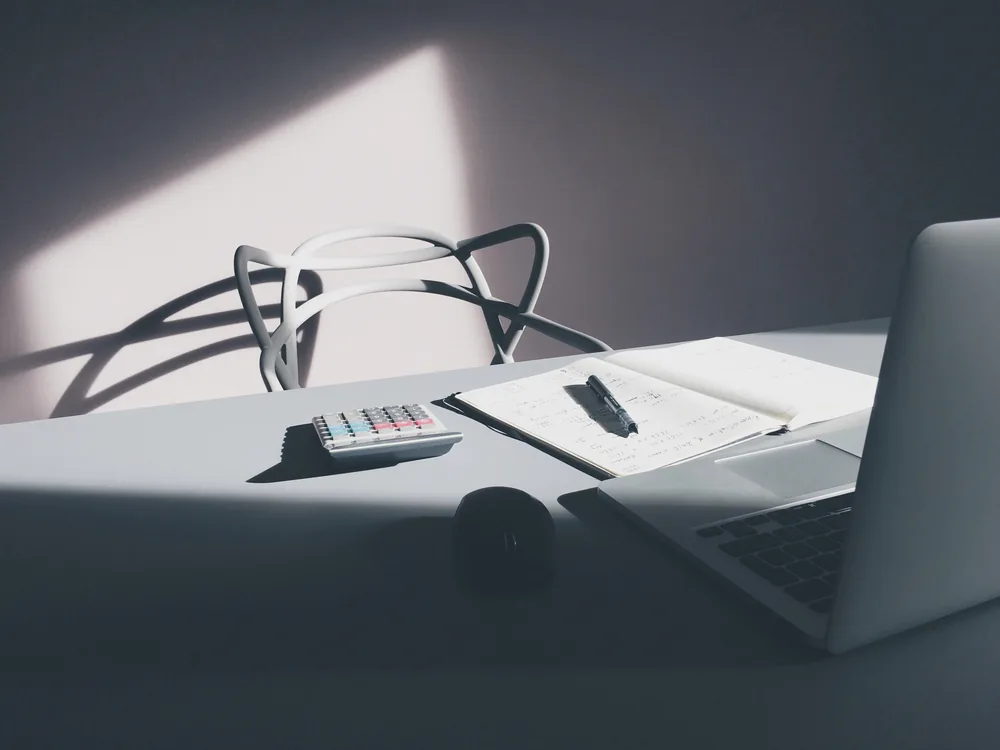 A laptop and a calculator on a desk